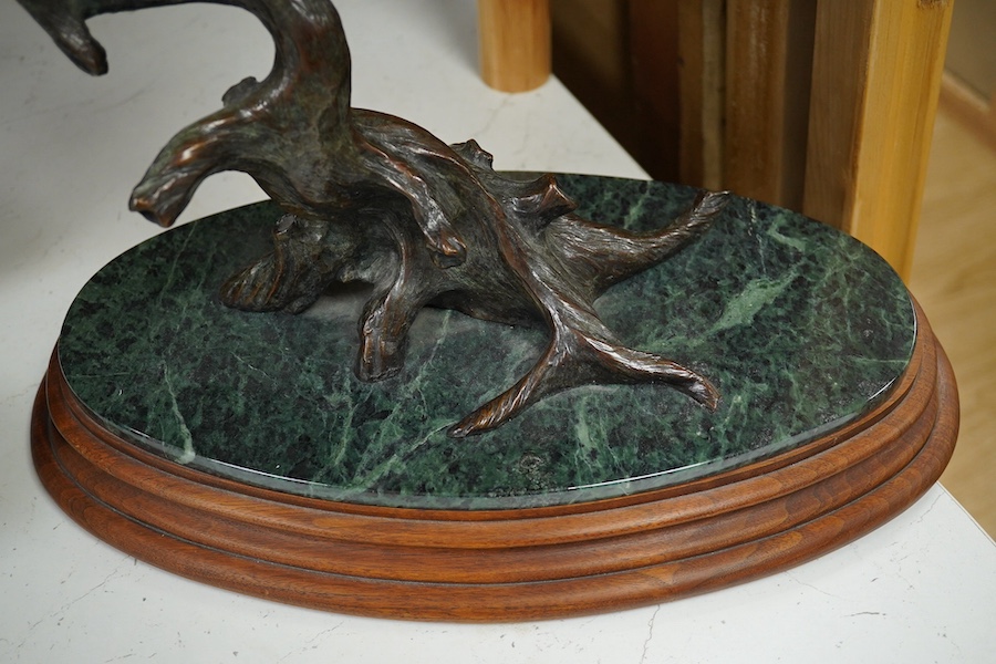 A modern large cast bronze sculpture of two flying geese, on an oval plinth, 90cm wide. Condition - good